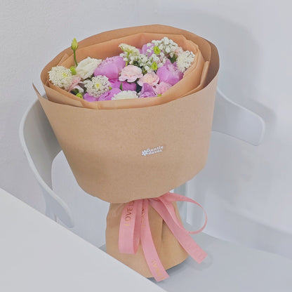 Eight Pink Peonies with Pink and White Flowers in Kraft Paper Rounded Bouquet