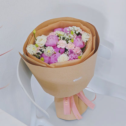 Eight Pink Peonies with Pink and White Flowers in Kraft Paper Rounded Bouquet