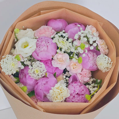 Eight Pink Peonies with Pink and White Flowers in Kraft Paper Rounded Bouquet