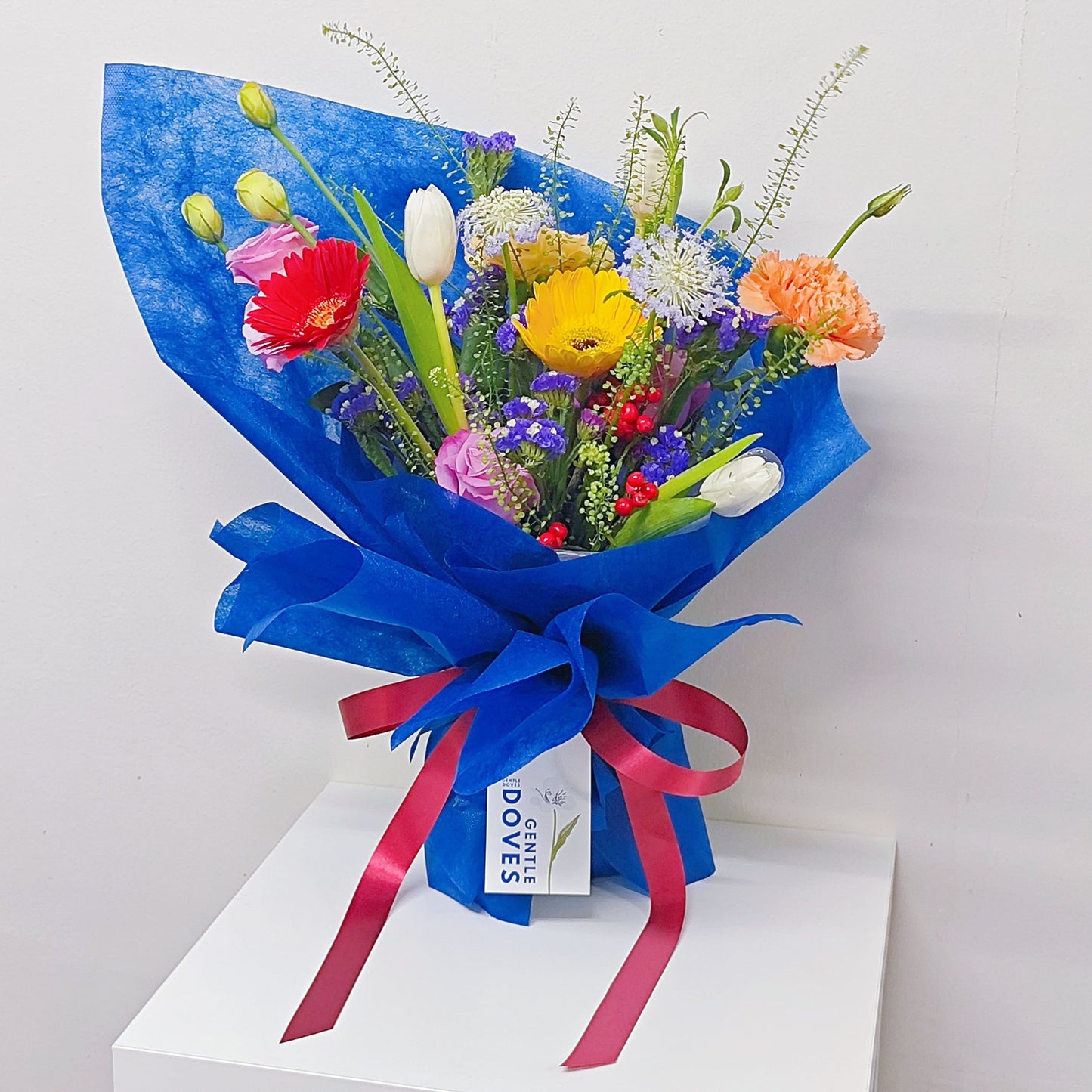 Assorted Colorful Flowers with Tulips in Blue Contrast Paper Medium Bouquet