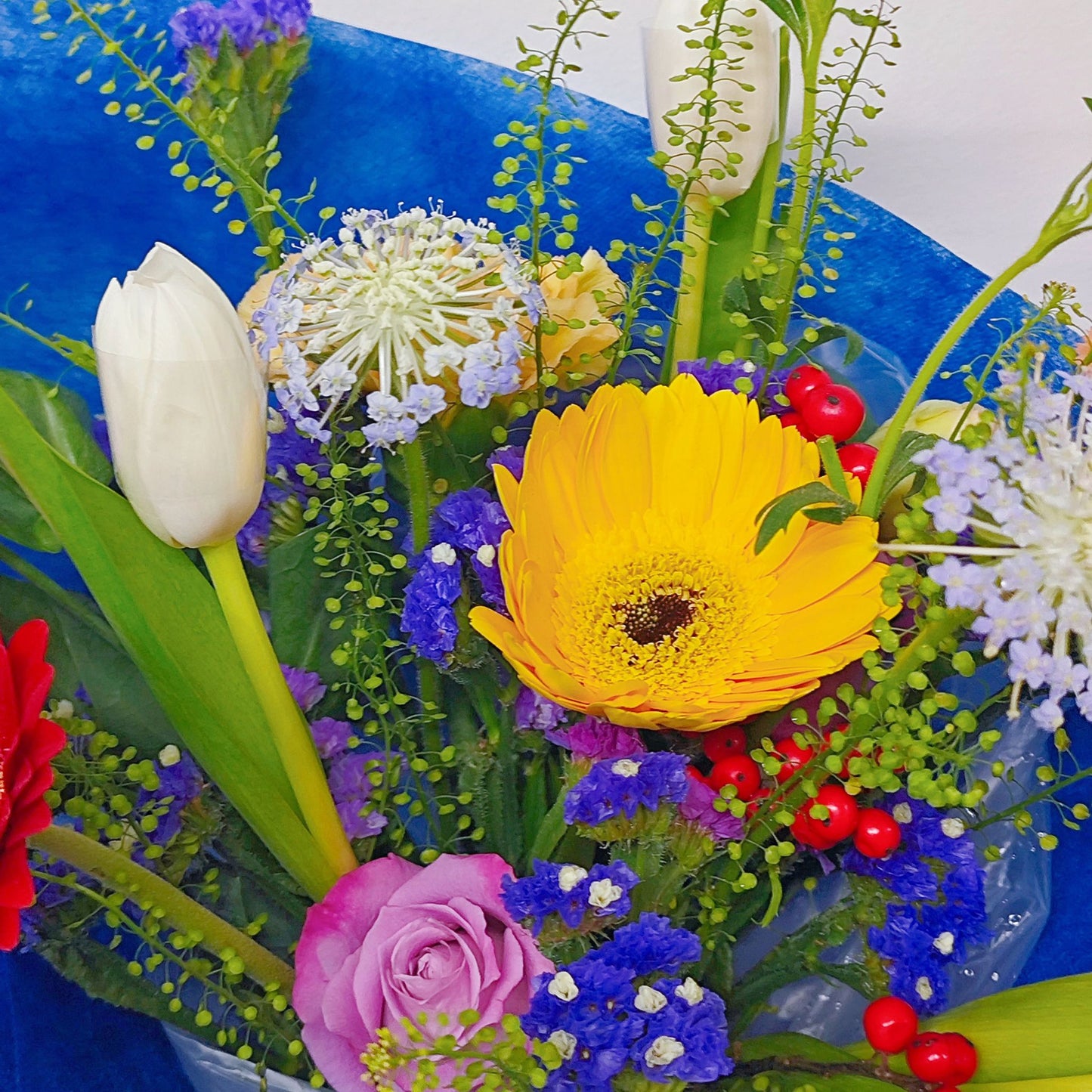 Assorted Colorful Flowers with Tulips in Blue Contrast Paper Medium Bouquet