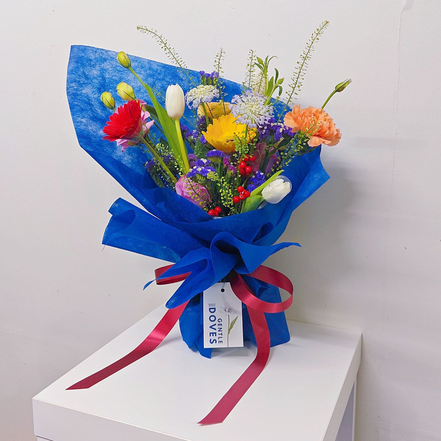 Assorted Colorful Flowers with Tulips in Blue Contrast Paper Medium Bouquet