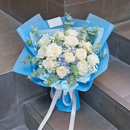Fifteen White English Roses with Blue Hydrangeas and Foliage in Blue Paper Bouquet