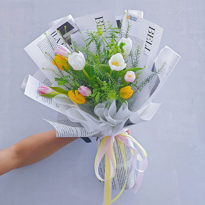 Assorted Ten Tulips in White, Pink and Yellow Colors with Green Foliage in Newspaper Pattern Bouquet