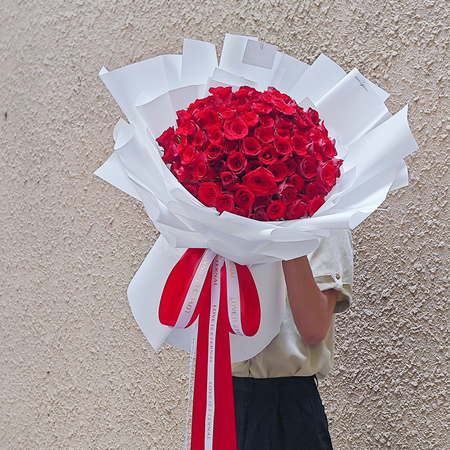 Ninety - Nine Red Roses in White Paper Bouquet