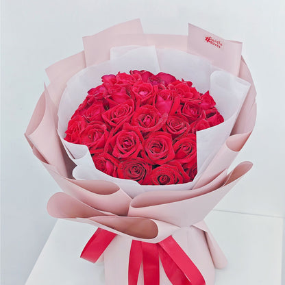 Thirty Red Roses in Pink Paper Bouquet