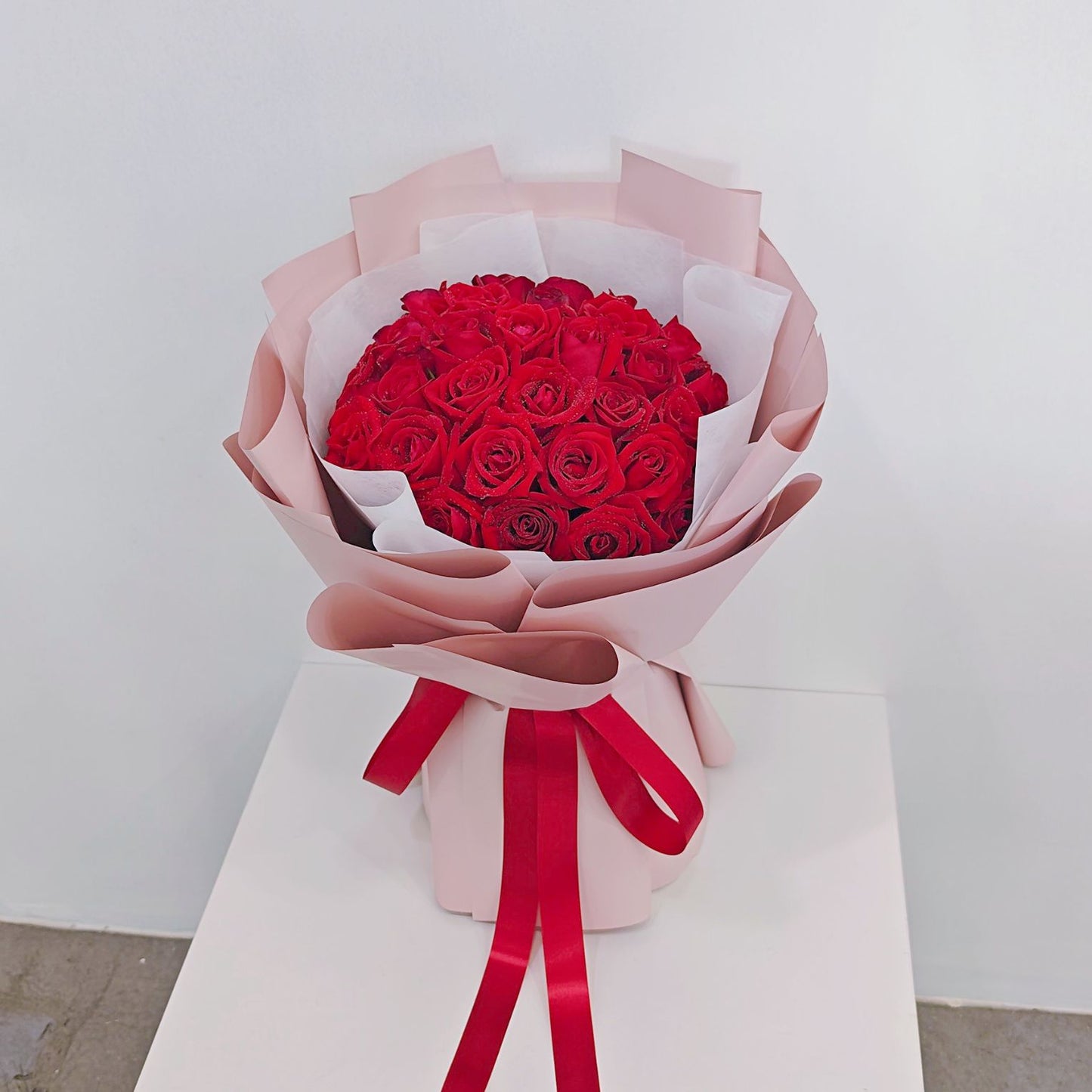 Thirty Red Roses in Pink Paper Bouquet