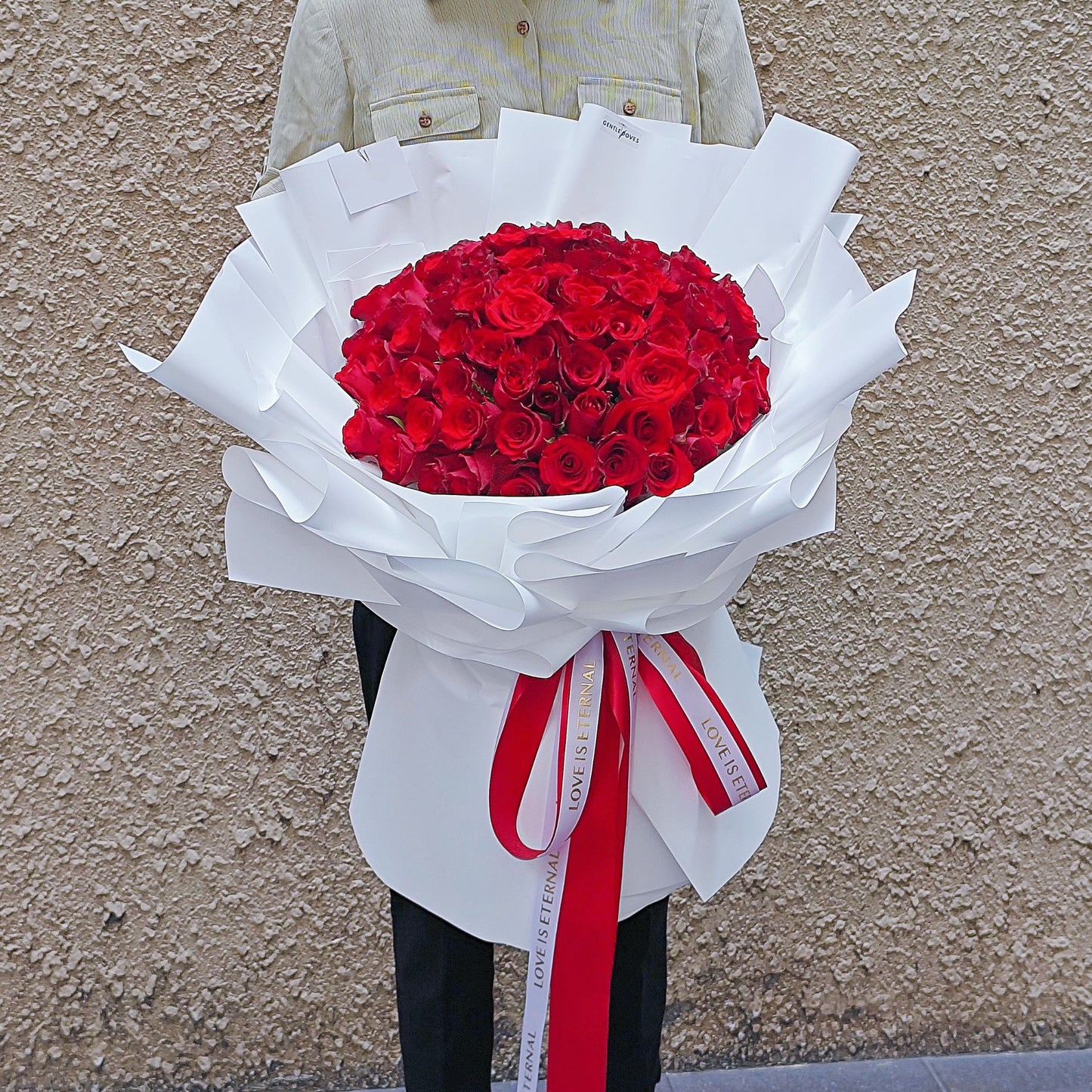 Ninety - Nine Red Roses in White Paper Bouquet