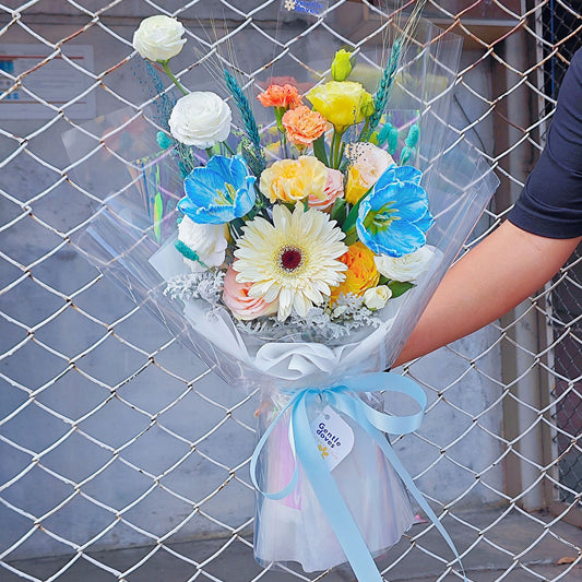 Assorted Blue Tone Flowers with Tulips in Transparent Paper Bouquet