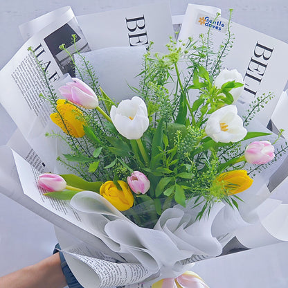 Assorted Ten Tulips in White, Pink and Yellow Colors with Green Foliage in Newspaper Pattern Bouquet