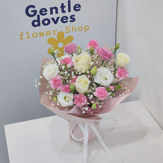 Assorted Pink Sprayed Carnations, lisianthus and White Roses in Small Vase Arrangement