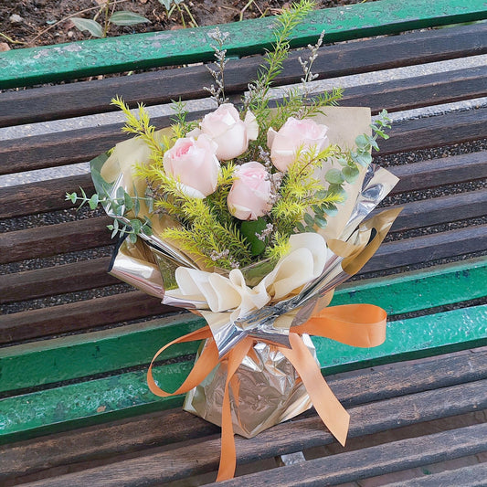 Four Soft Pink Roses with Foliage in Beige Aluminum Paper Bouquet