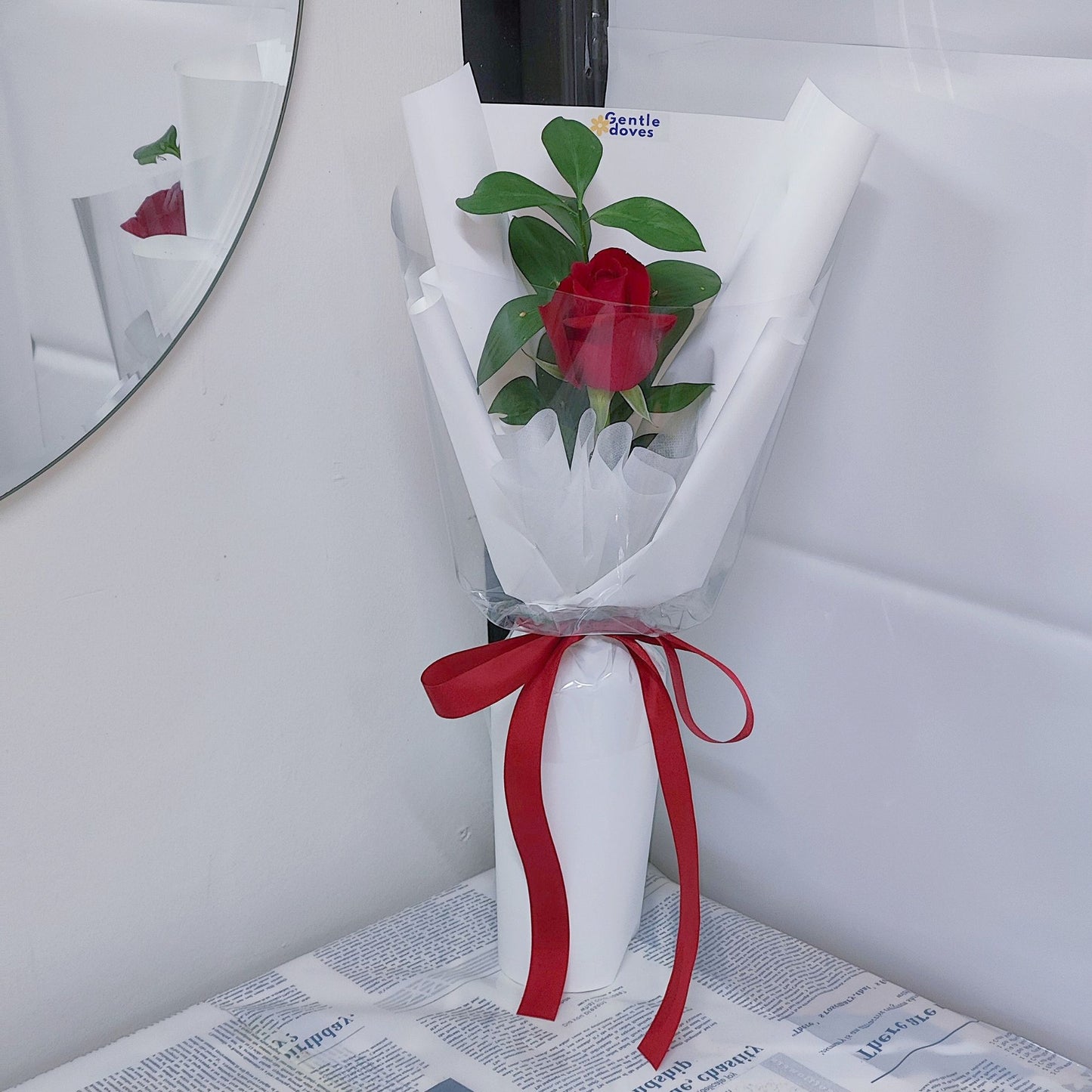 Single Red Rose with Foliage in White Paper Bouquet