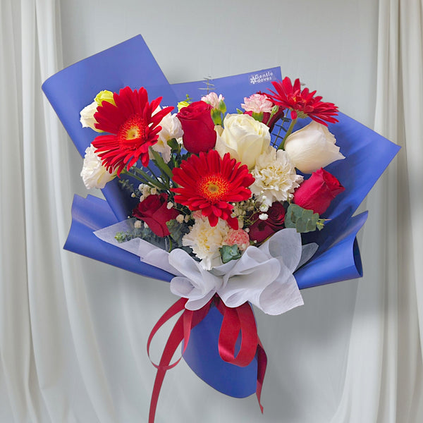 Assorted Red and White Flowers in Blue Paper Medium Bouquet