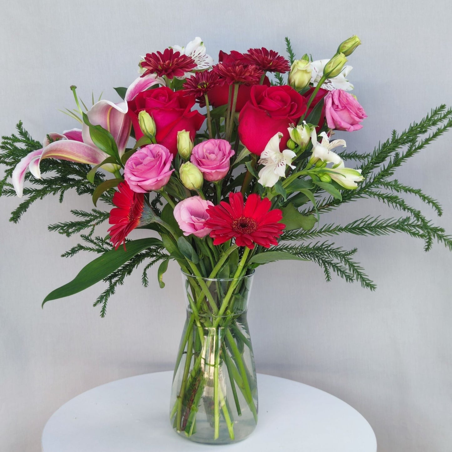 Assorted Pink and Red Tones Flowers in Large Vase Arrangement