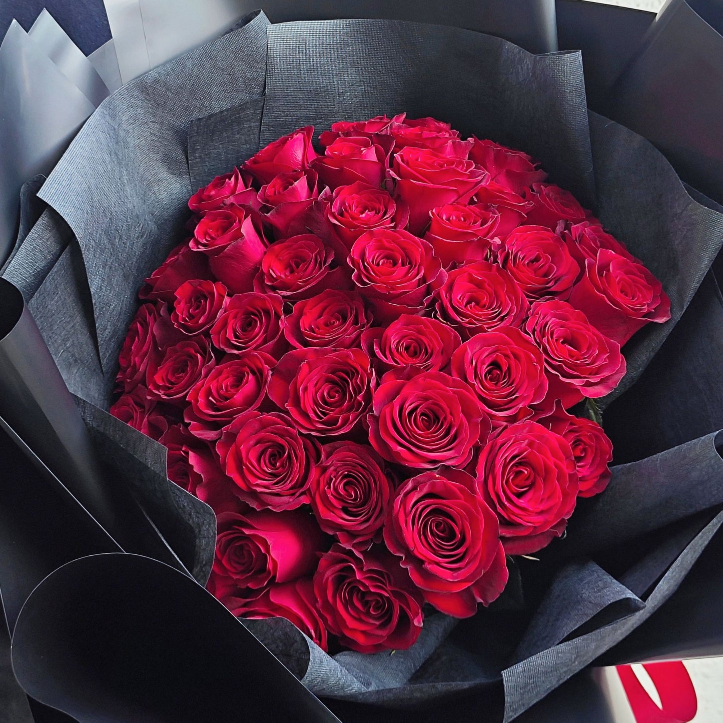 Imported Fifty Red Roses in Black Paper Bouquet