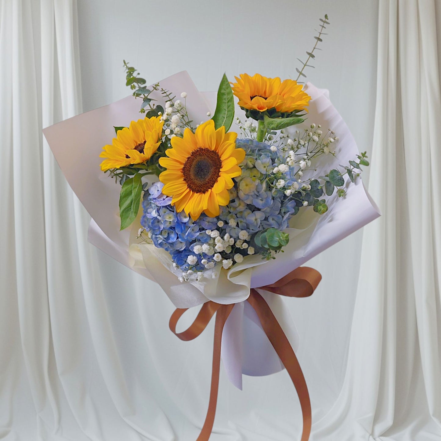 Three Sunflowers with Blue Hydrangeas and Filler Flowers Medium Bouquet