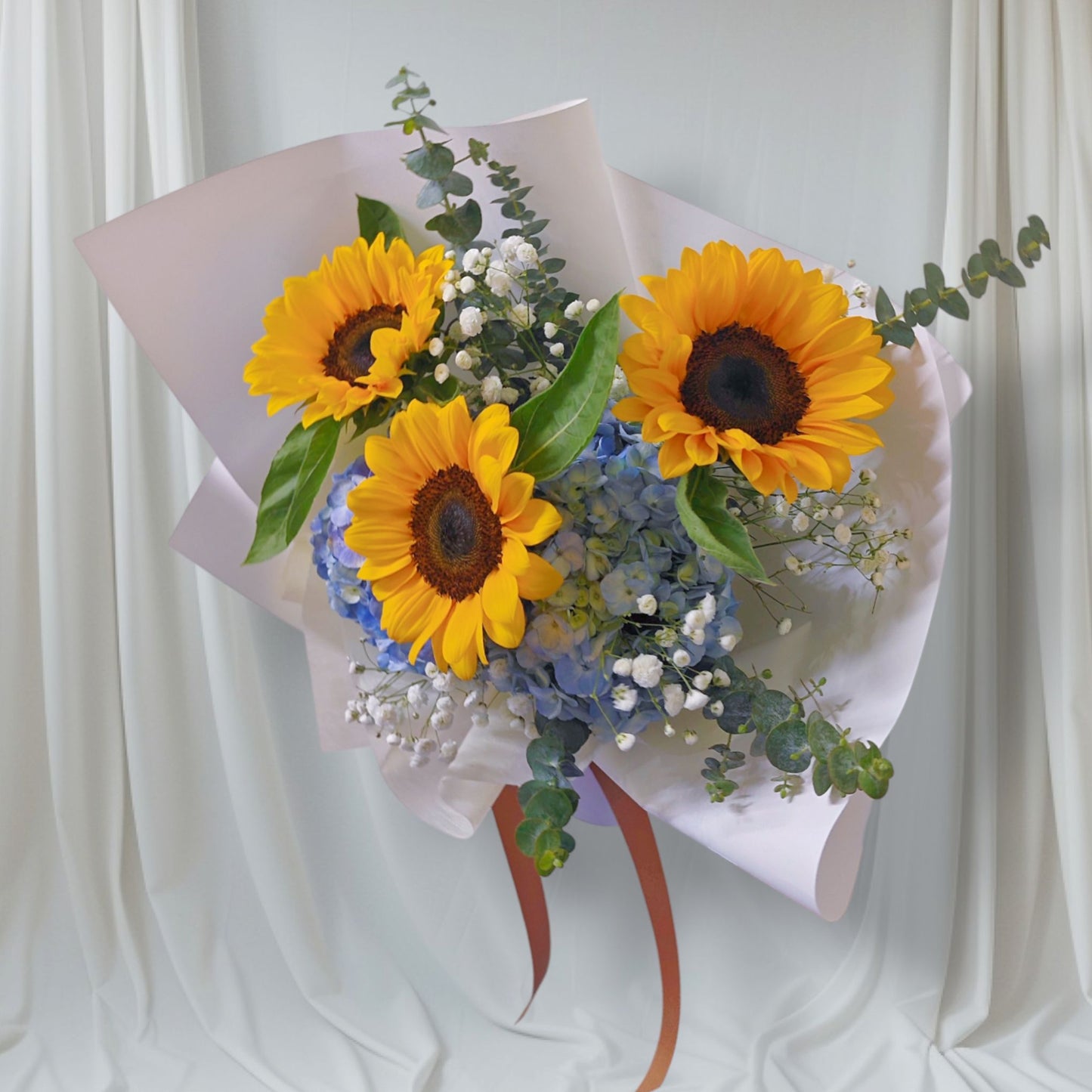 Three Sunflowers with Blue Hydrangeas and Filler Flowers Medium Bouquet