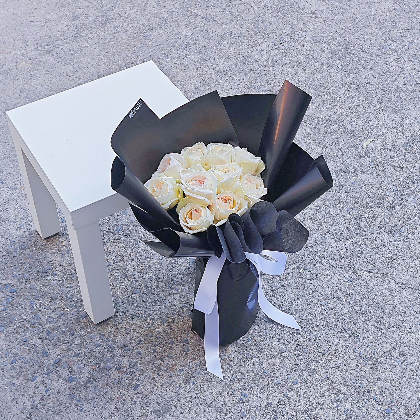 White English Roses in Black Paper Bouquet