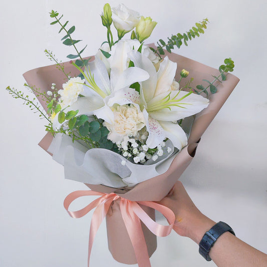 White Lilies with Foliage in Soft Brown Paper Small Bouquet