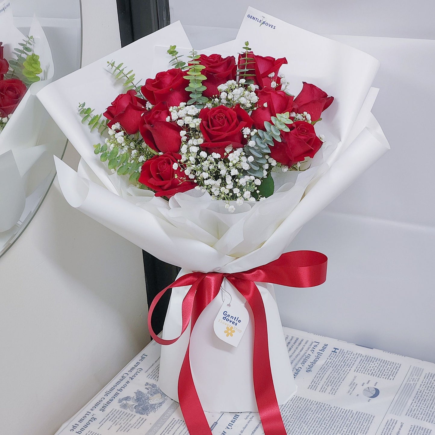 Twelve Red Roses with Eucalyptus and Gypsophila in White Paper Bouquet