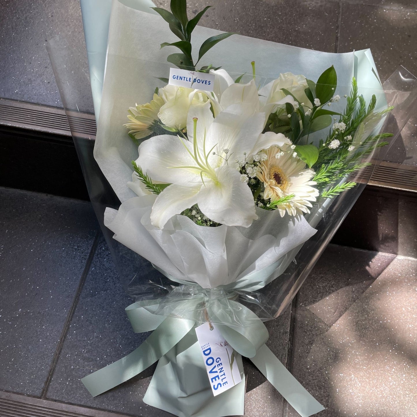 White Flowers in Soft Green Paper Bouquet