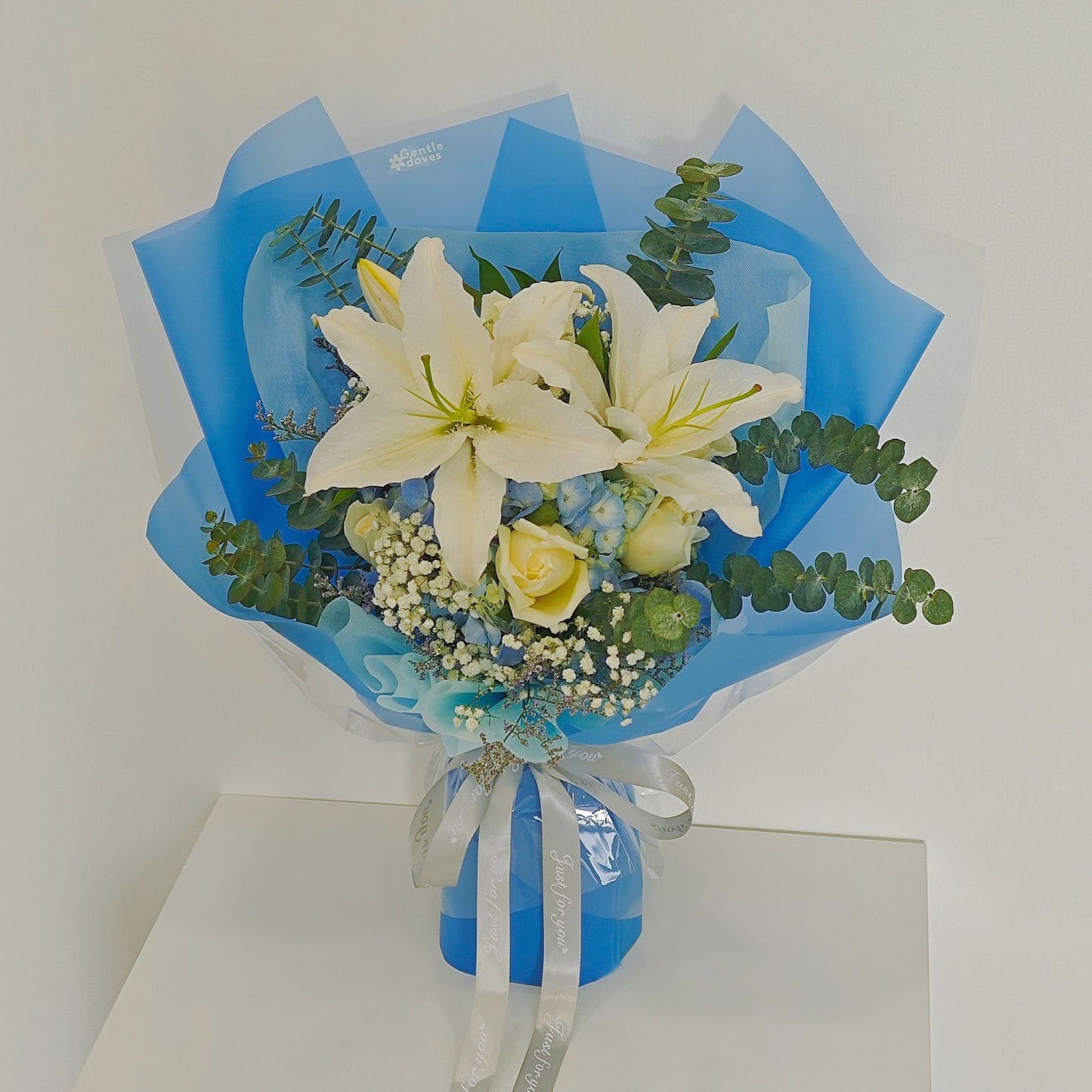White Lilies with Blue Hydrangeas and Foliages Large Bouquet