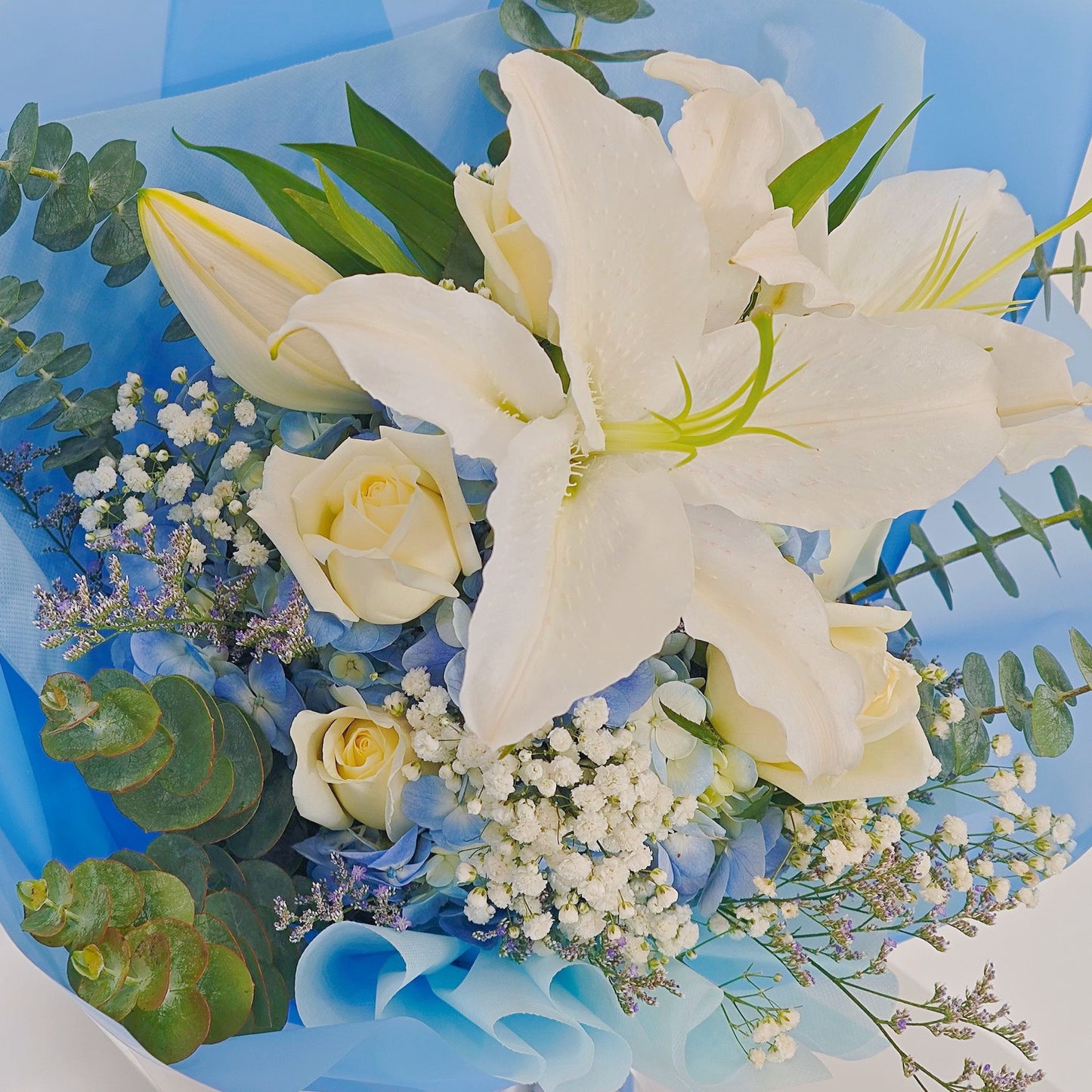 White Lilies with Blue Hydrangeas and Foliages Large Bouquet