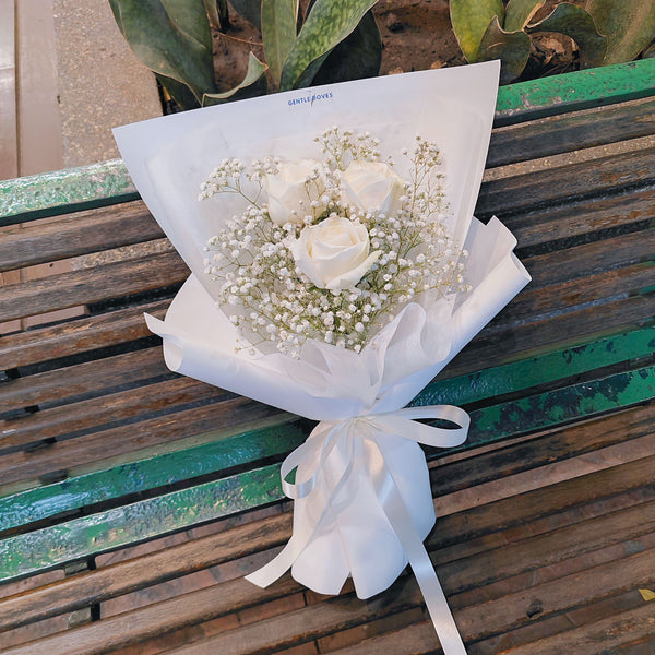 Three Imported White Roses with Gypsophila in White Paper Bouquet