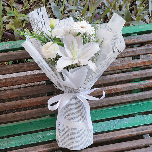 Single White Lily with White Flowers in Newspaper Bouquet