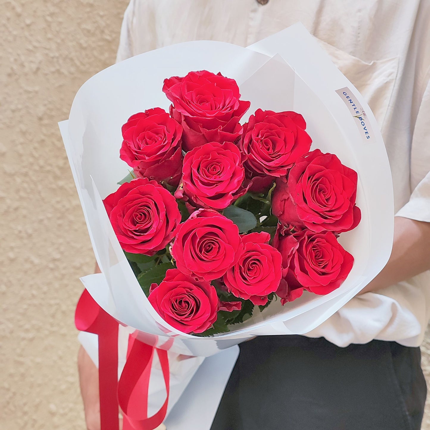 Ten Imported Red Roses in White Paper Bouquet