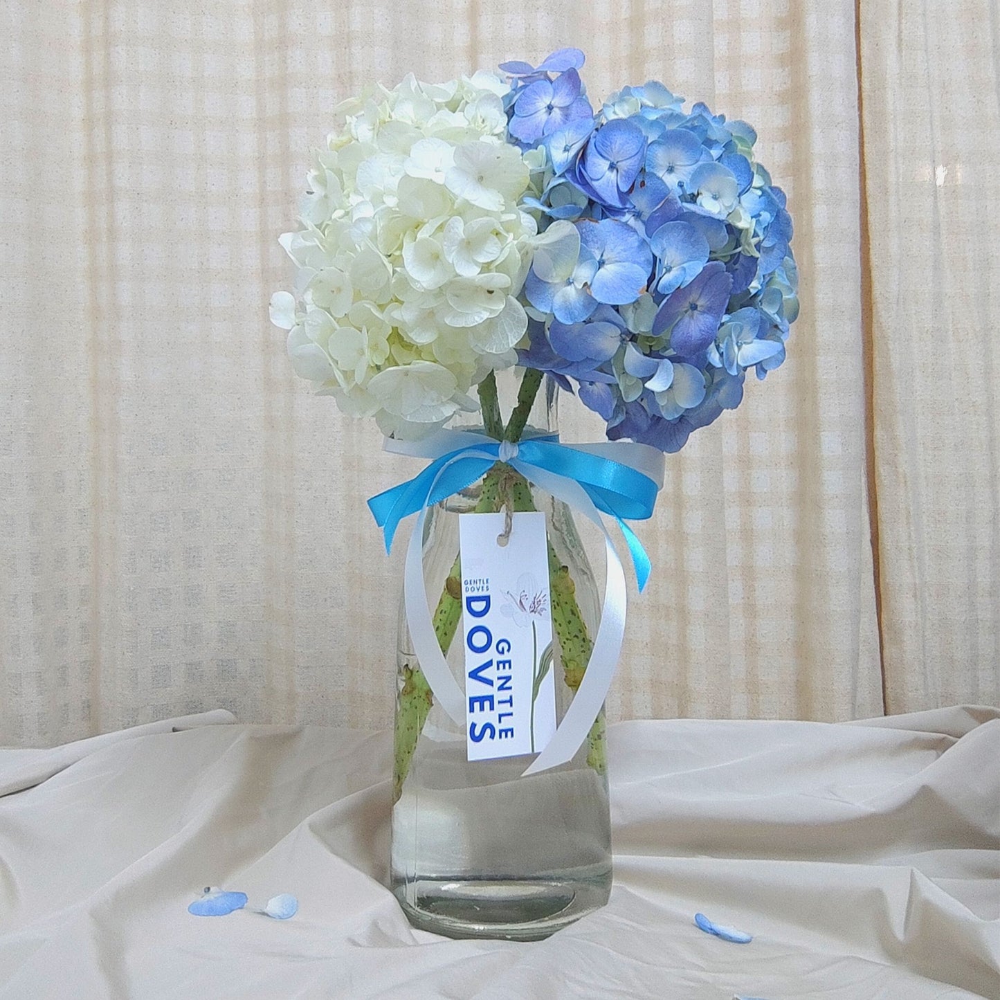 Blue and White Hydrangeas in Tall Vase Arrangement