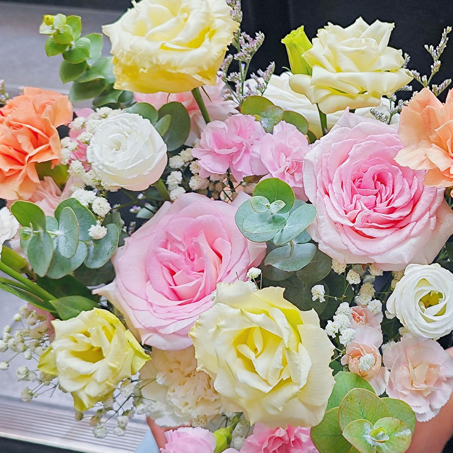 Assorted Pink and Yellow Flowers in Small Paper Box Arrangement