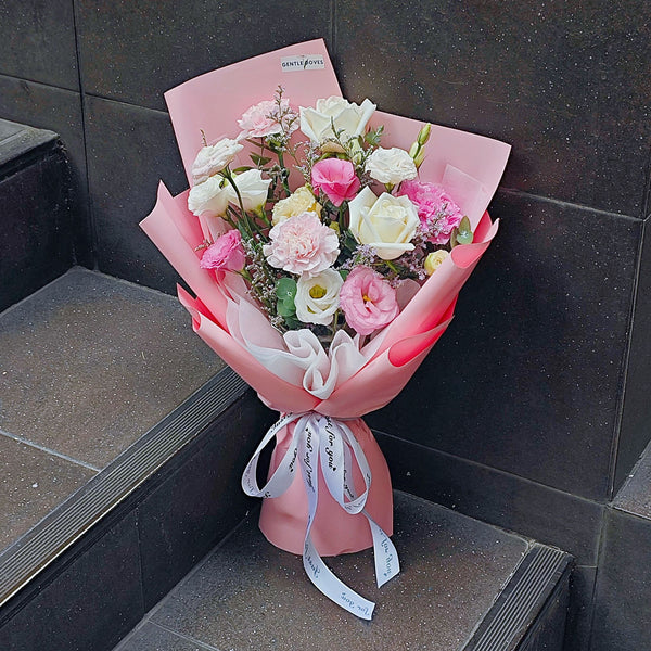 Assorted Pink and White Flowers in Pink Paper Bouquet