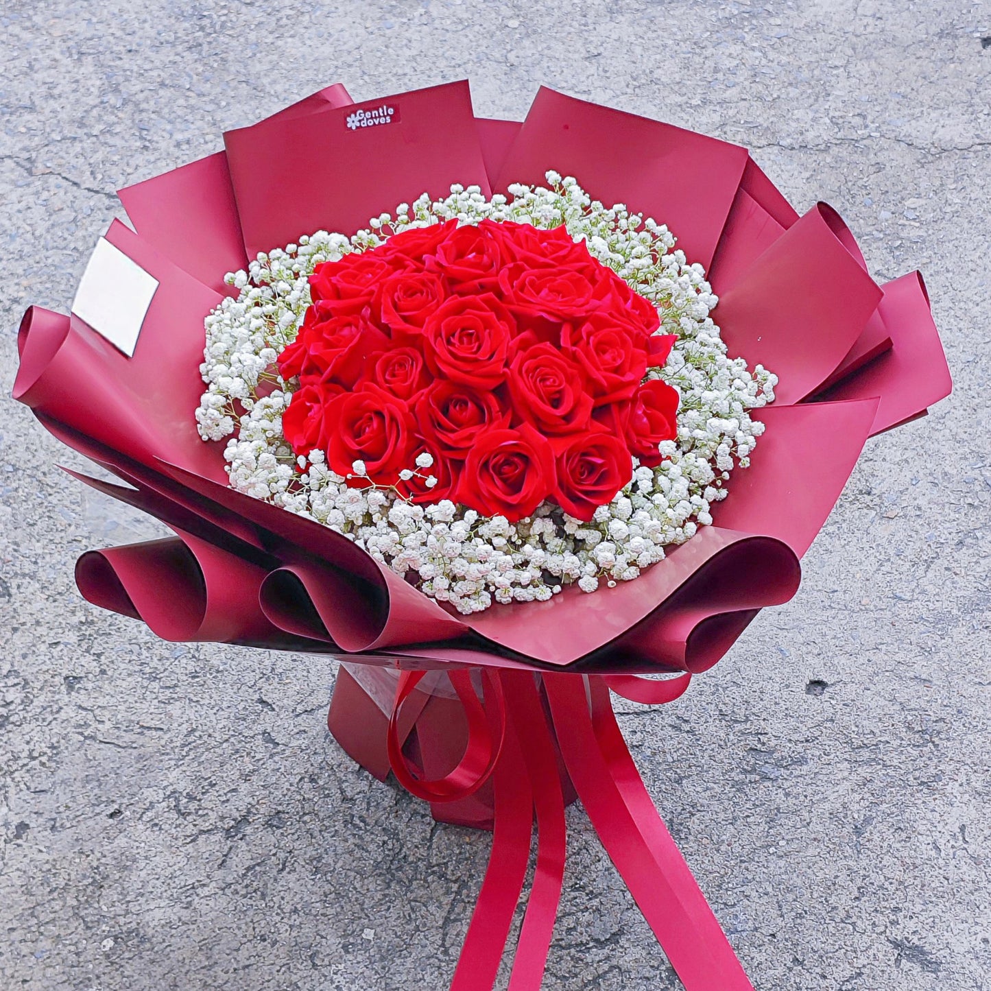 Twenty Four Red Roses Surrouded with Gypsophila in Red Paper Bouquet