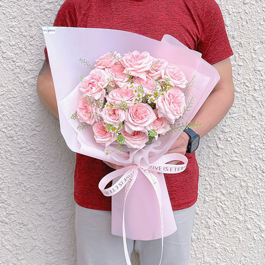 Fifteen Soft Pink English Roses with Pepper Grass and Daisies in Pink Paper Bouquet