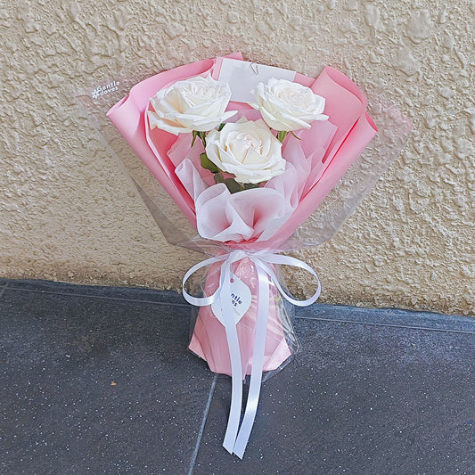 Three White English Roses in Pink Paper Small Bouquet