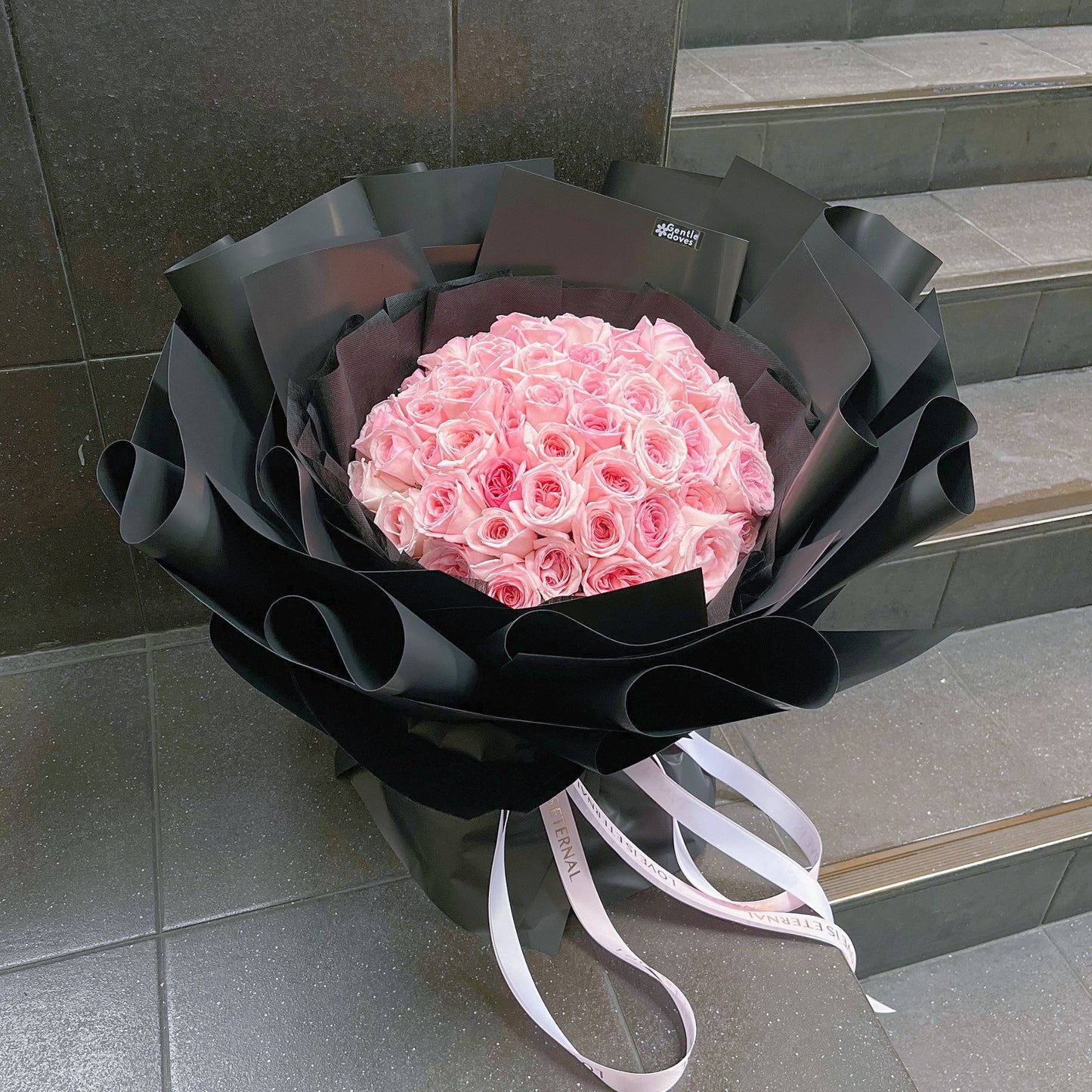 Seventy Soft Pink English Roses in Black Paper Bouquet