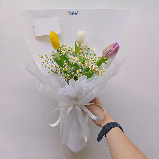 Three Assorted Color Tulips with Daisies in White Paper Bouquet