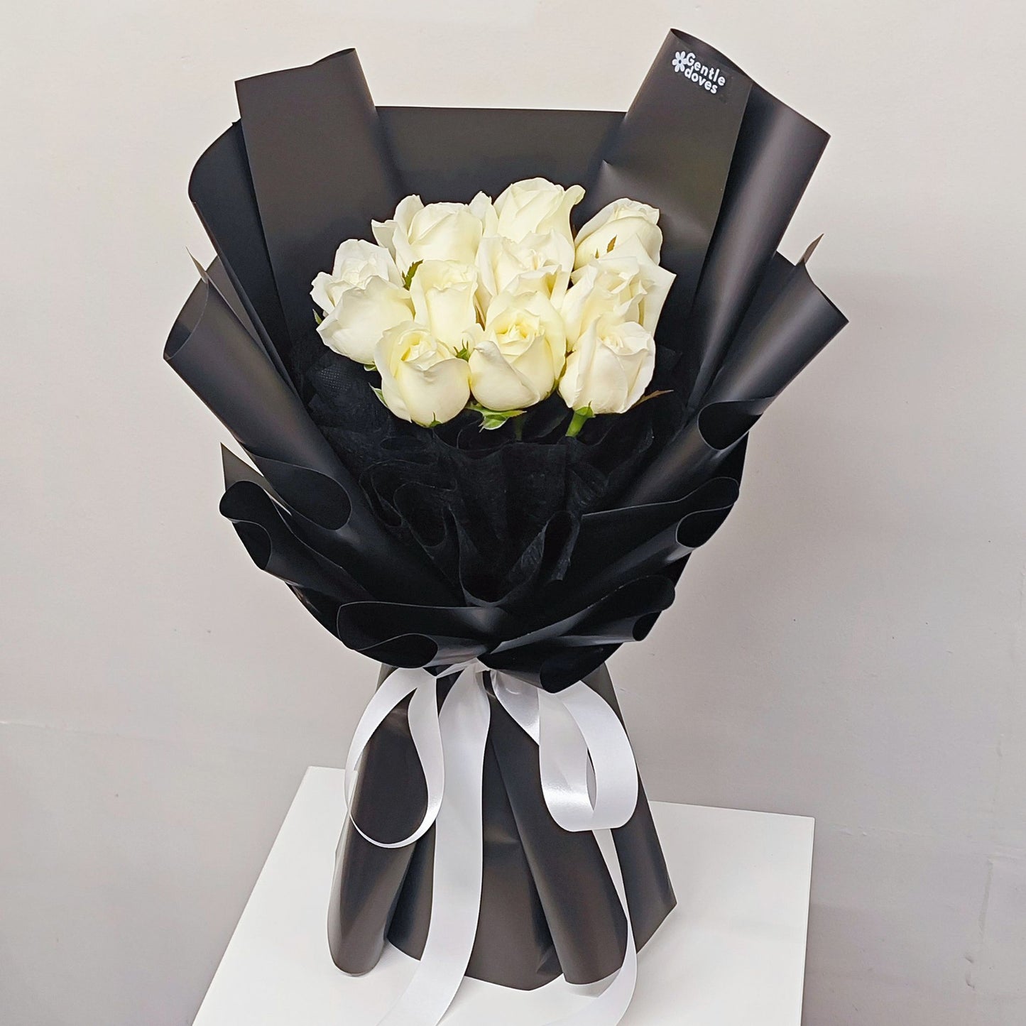 Ten White Roses in Black Paper Bouquet