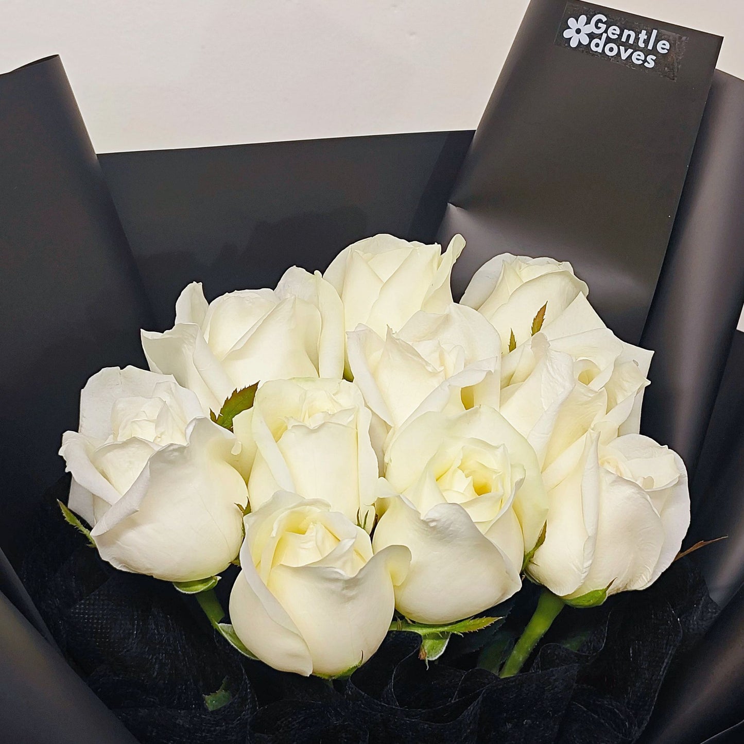 Ten White Roses in Black Paper Bouquet