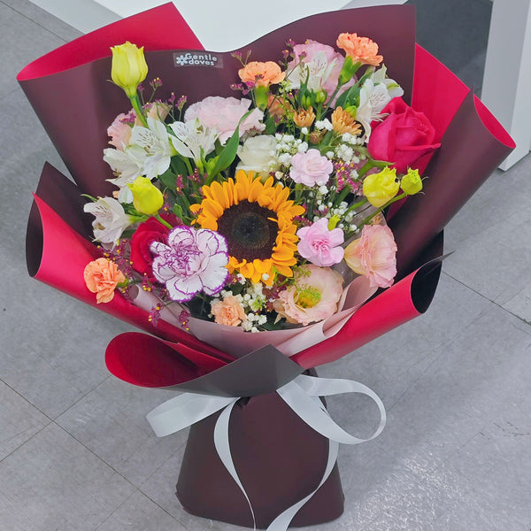 Assorted Vivid and Colorful Flowers in Red Paper Bouquet