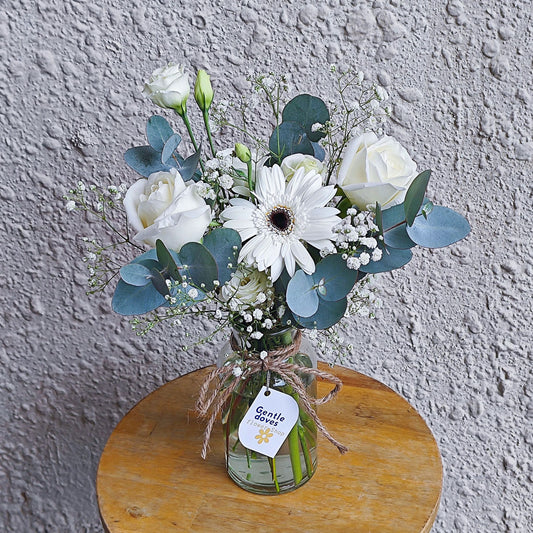 Assorted White Roses and Gerberas with Green Foliage in Small Vase Arrangement