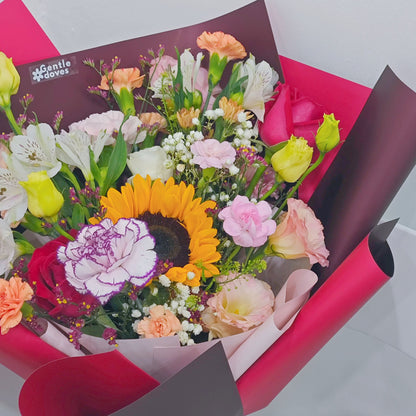 Assorted Vivid and Colorful Flowers in Red Paper Bouquet