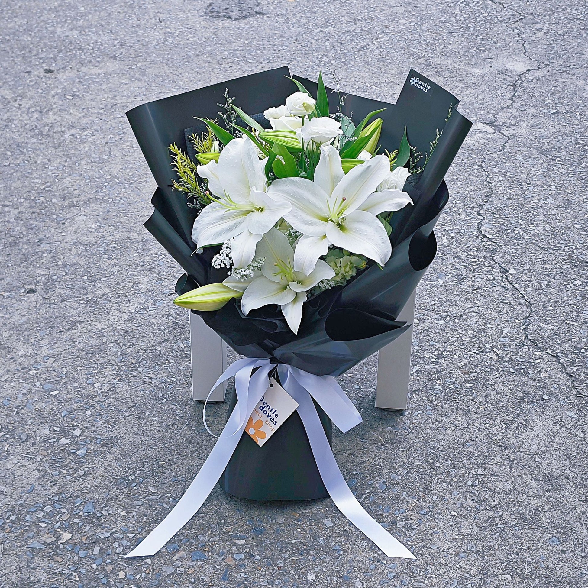 black roses and white lilies White Lilies with Assorted White Flowers in Black Paper Bouquet – Gentle Doves Flower Shop