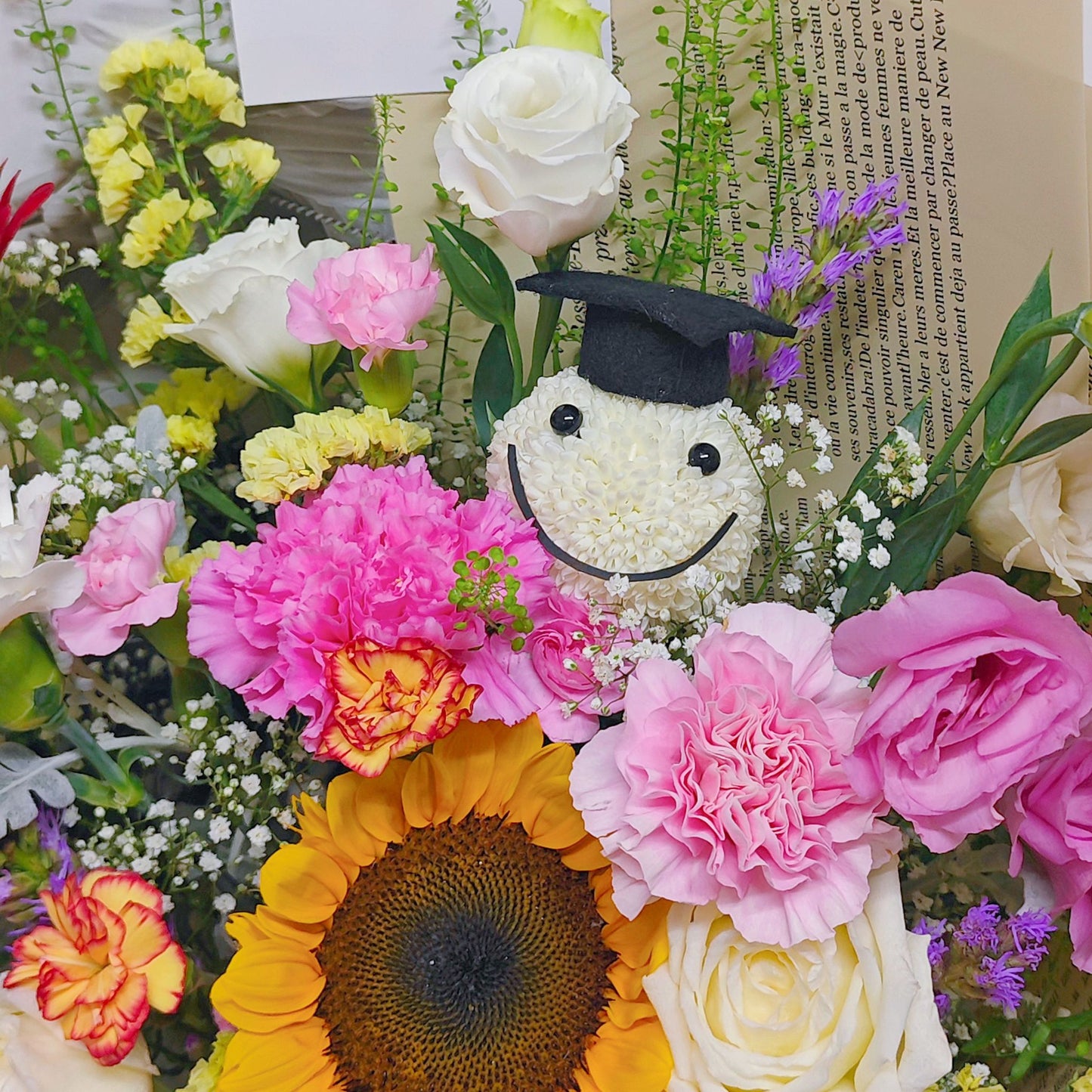 Assorted Colorful Flowers with Graduated Smiley Face in Golden Newspaper Bouquet