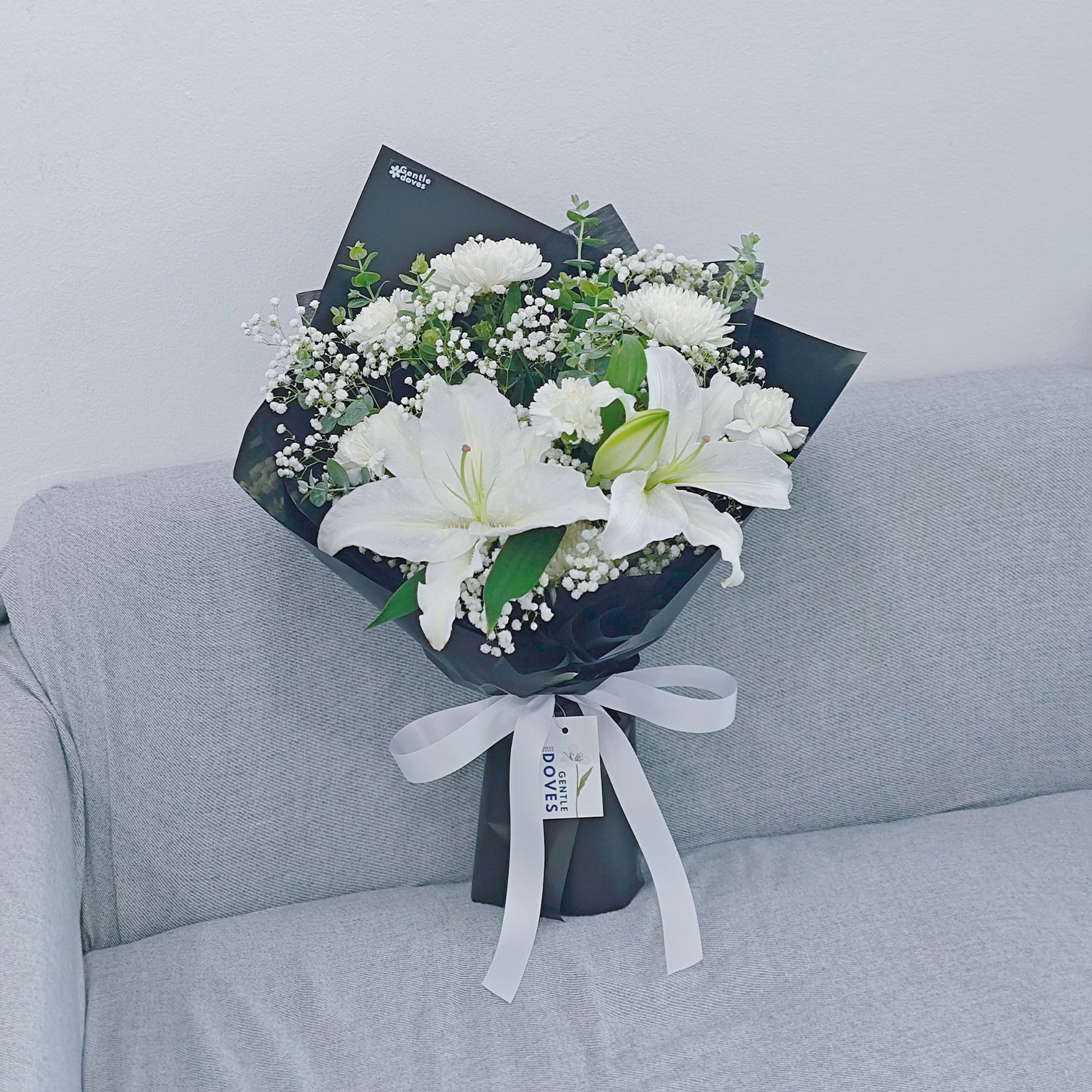 paper white lily White Lilies with White Flowers and Foliage in Black Paper Bouquet – Gentle Doves Flower Shop