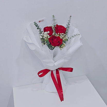Three Red Roses with Gypsophila and Eucalyptus in White Paper Bouquet