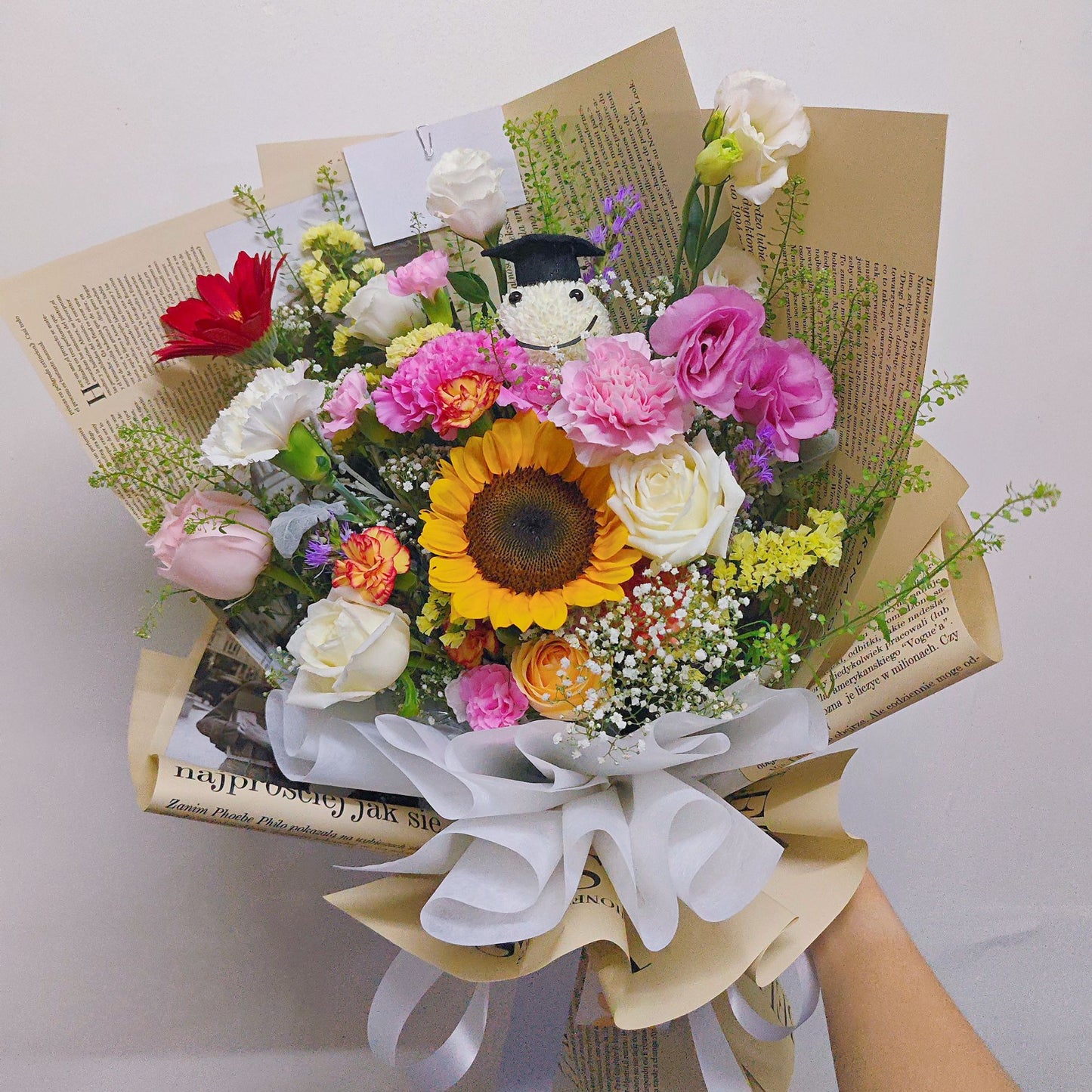 Assorted Colorful Flowers with Graduated Smiley Face in Golden Newspaper Bouquet