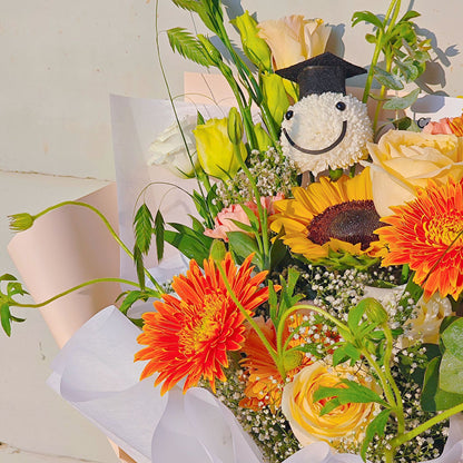 Assorted Orange and Yellow Flowers with Graduated Smiley Face Bouquet